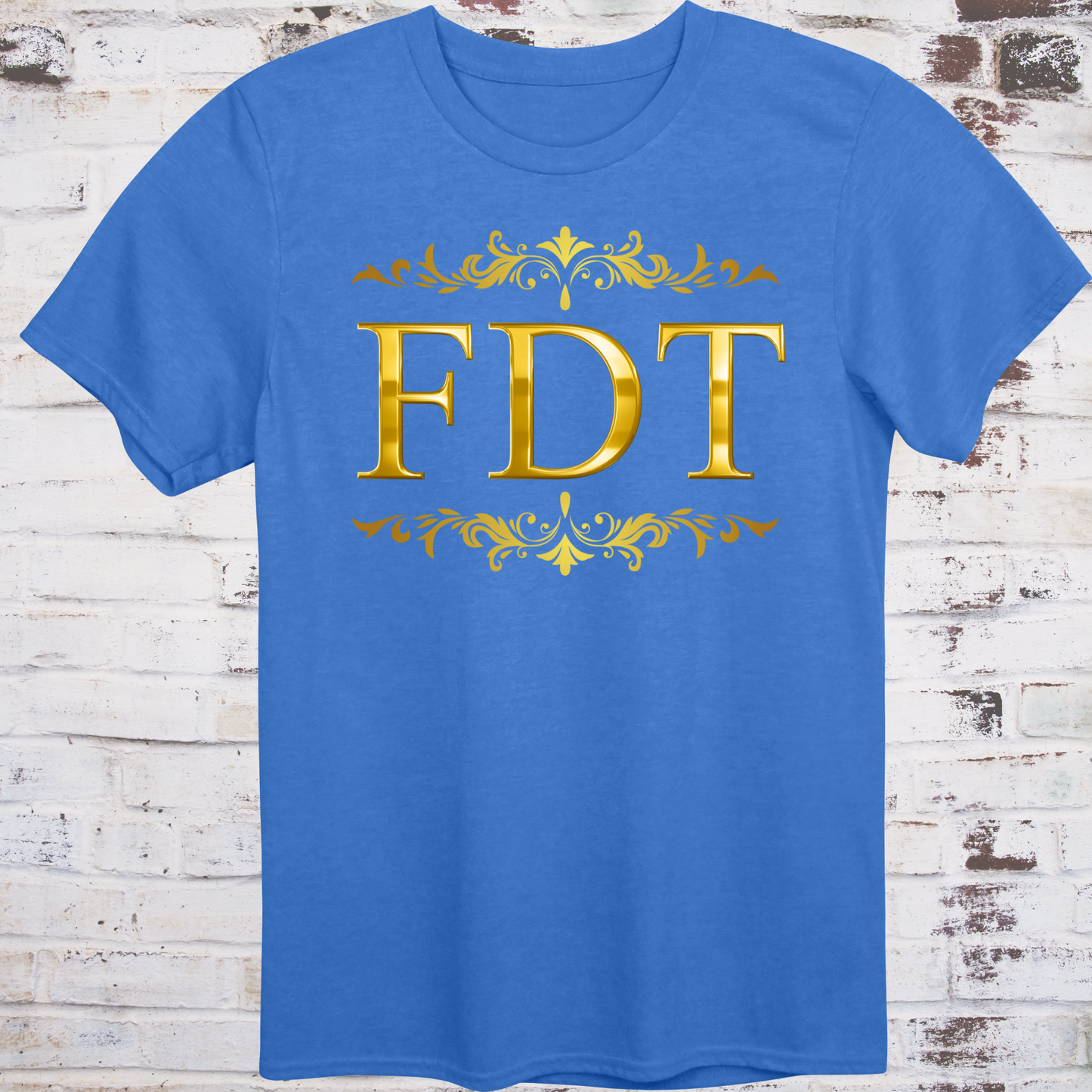 Blue t-shirt with ornate gold design and bold letters “FDT”
framed in decorative scrollwork – luxury-style protest shirt by Democratee’s