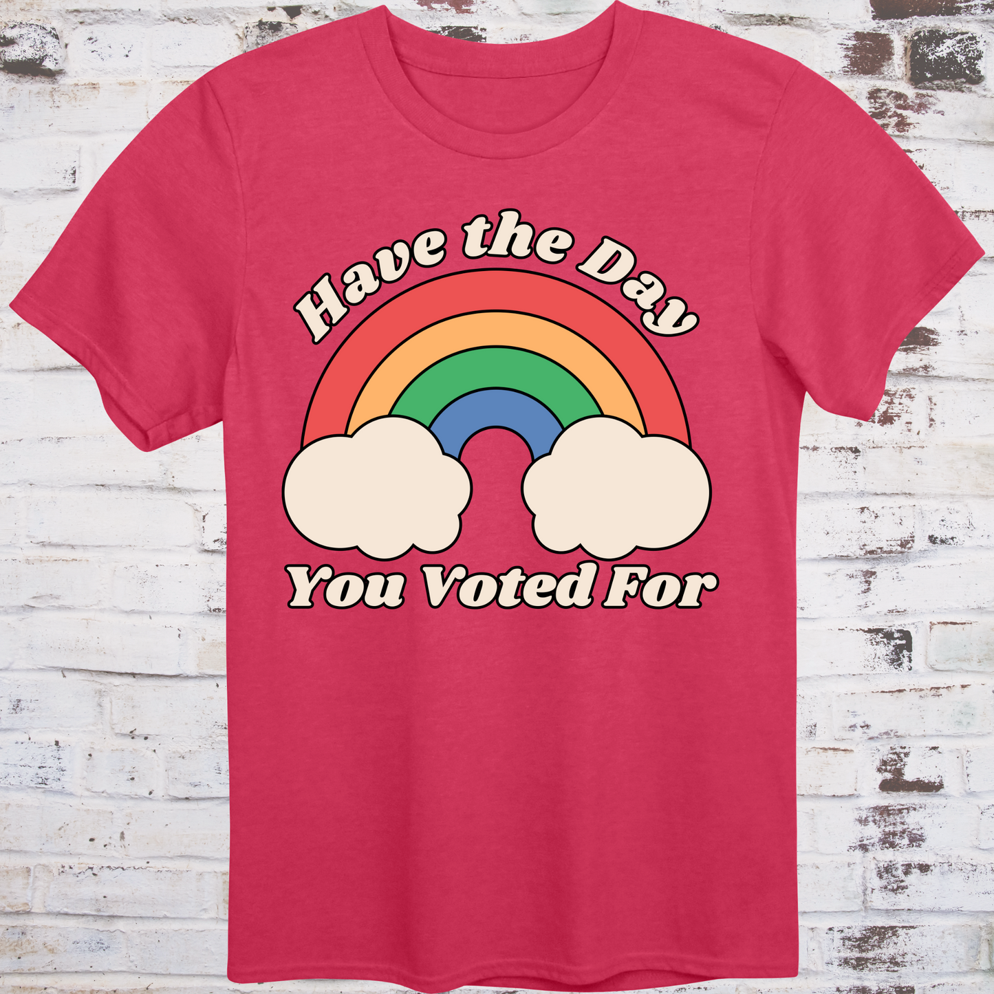 Red t-shirt with retro rainbow graphic and white text reading
“Have the Day You Voted For” – passive-aggressive protest shirt by Democratee’s