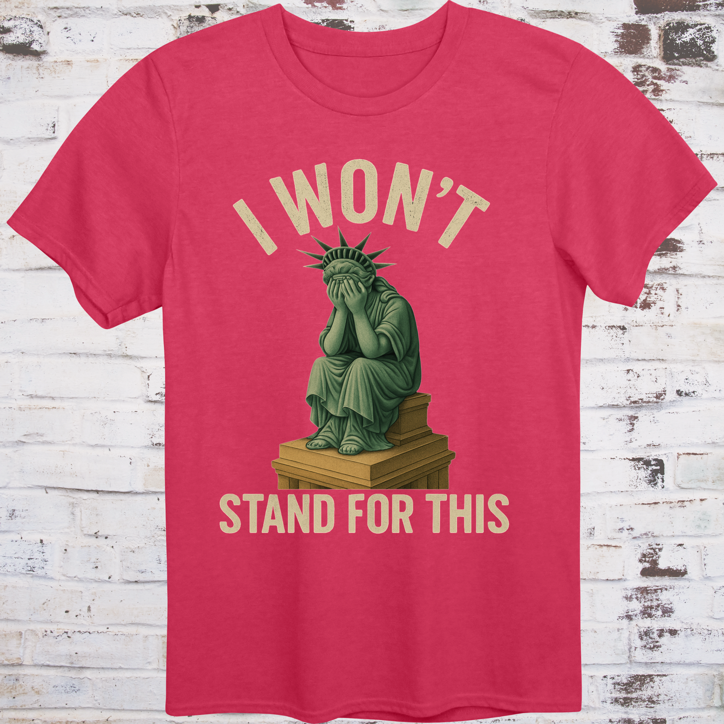 Red t-shirt with illustration of the Statue of Liberty
sitting on a pedestal with her face in her hands,
under text reading "I Won’t Stand for This" –
progressive protest shirt by Democratee’s