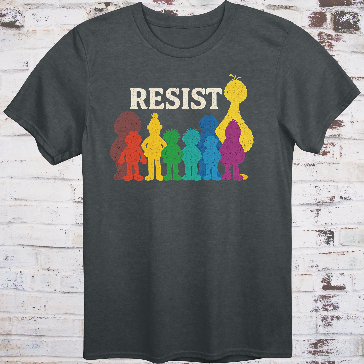 Gray t-shirt with bold white RESIST text above rainbow-colored silhouettes
of classic children’s characters – pride and protest shirt by Democratee’s