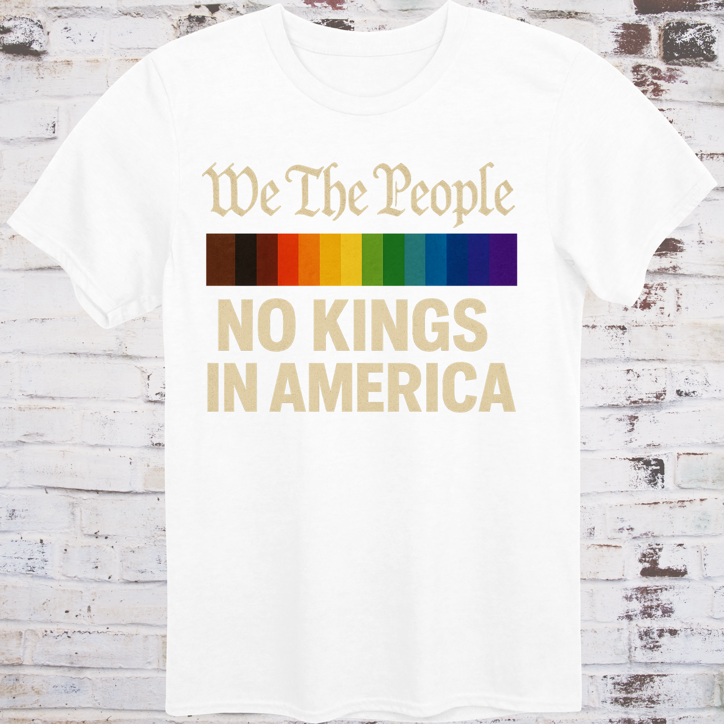White t-shirt with the phrase 'We The People' in old script above a Progress Pride flag, and bold text below reading 'No Kings in America' — a pro-democracy, LGBTQ+ inclusive design."