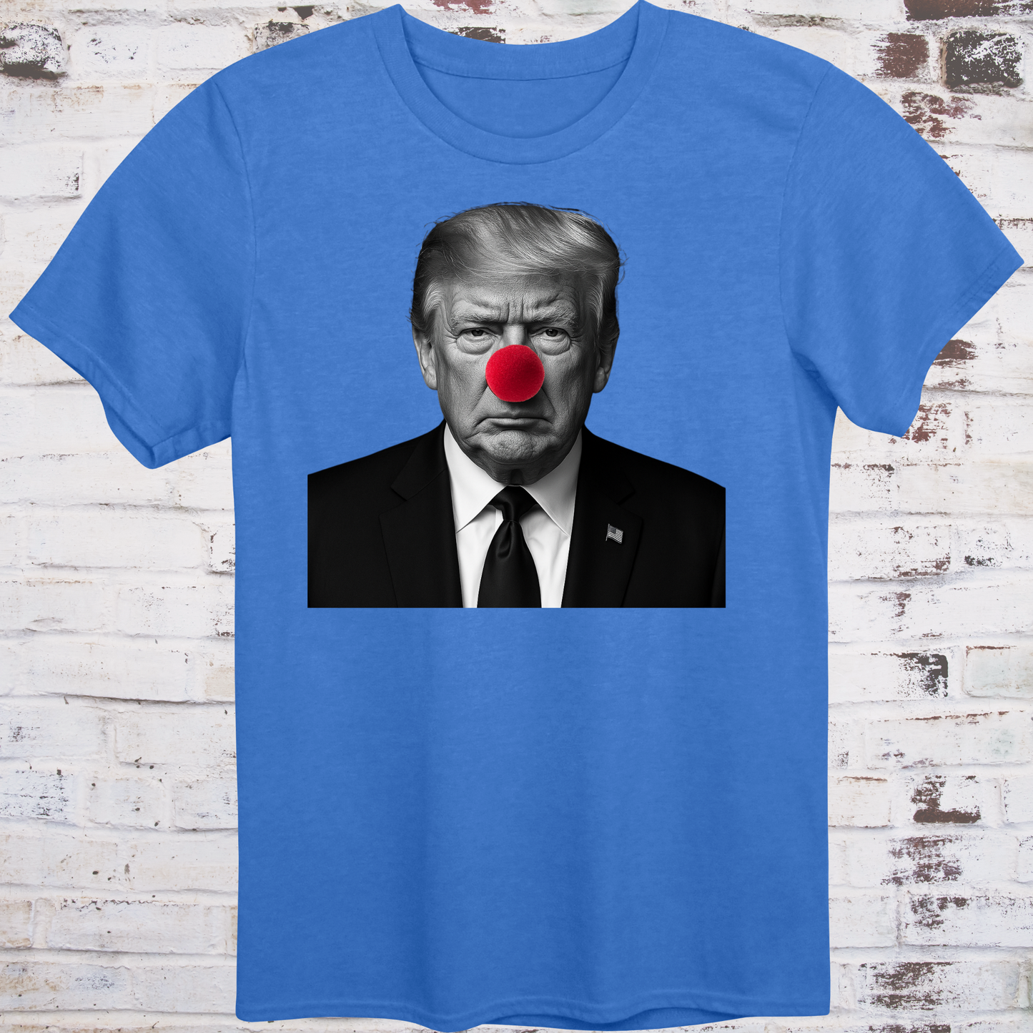 Blue t-shirt with black-and-white photo of Donald Trump wearing a red clown nose –
minimalist parody protest shirt by Democratee’s