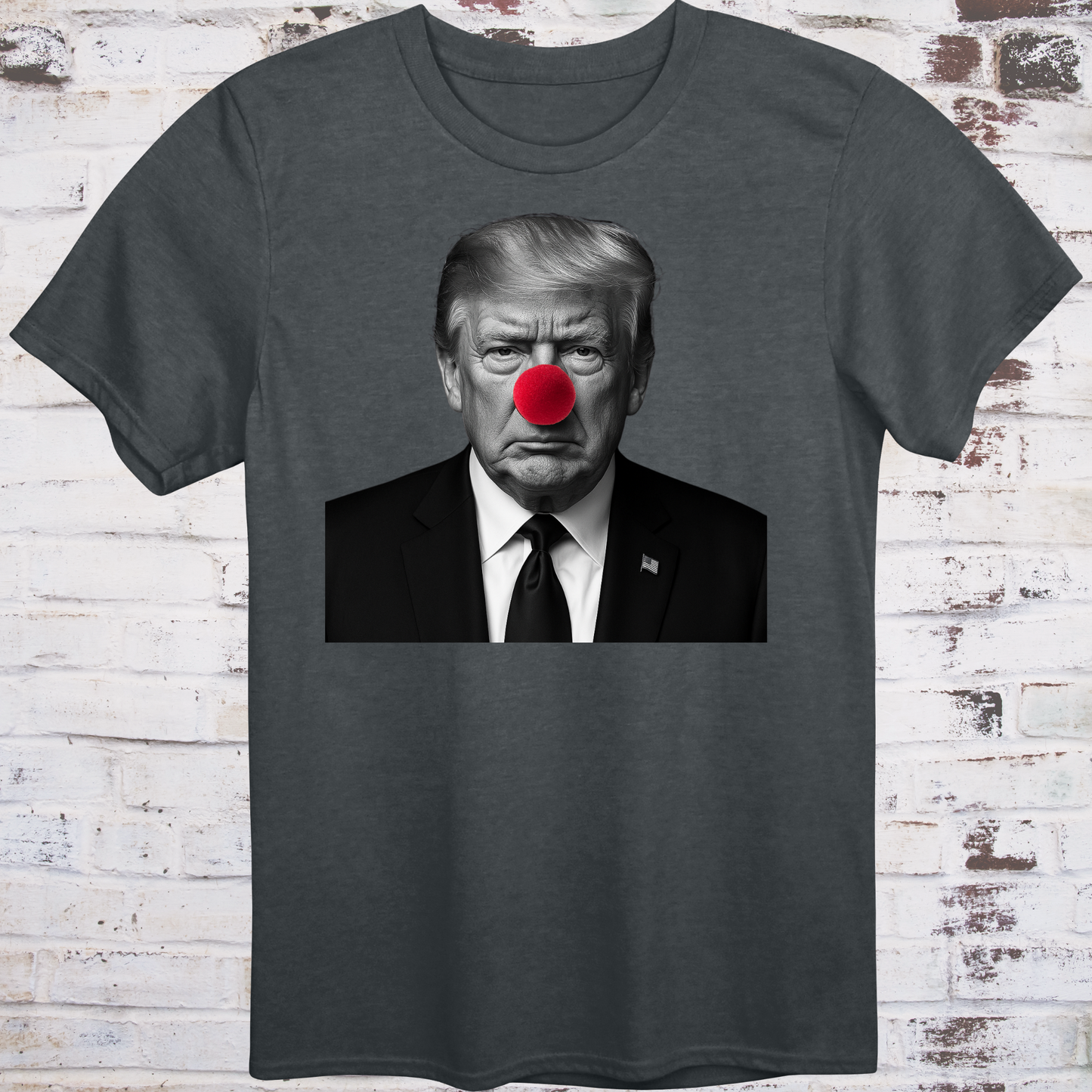 Gray t-shirt with black-and-white photo of Donald Trump wearing a red clown nose –
minimalist parody protest shirt by Democratee’s