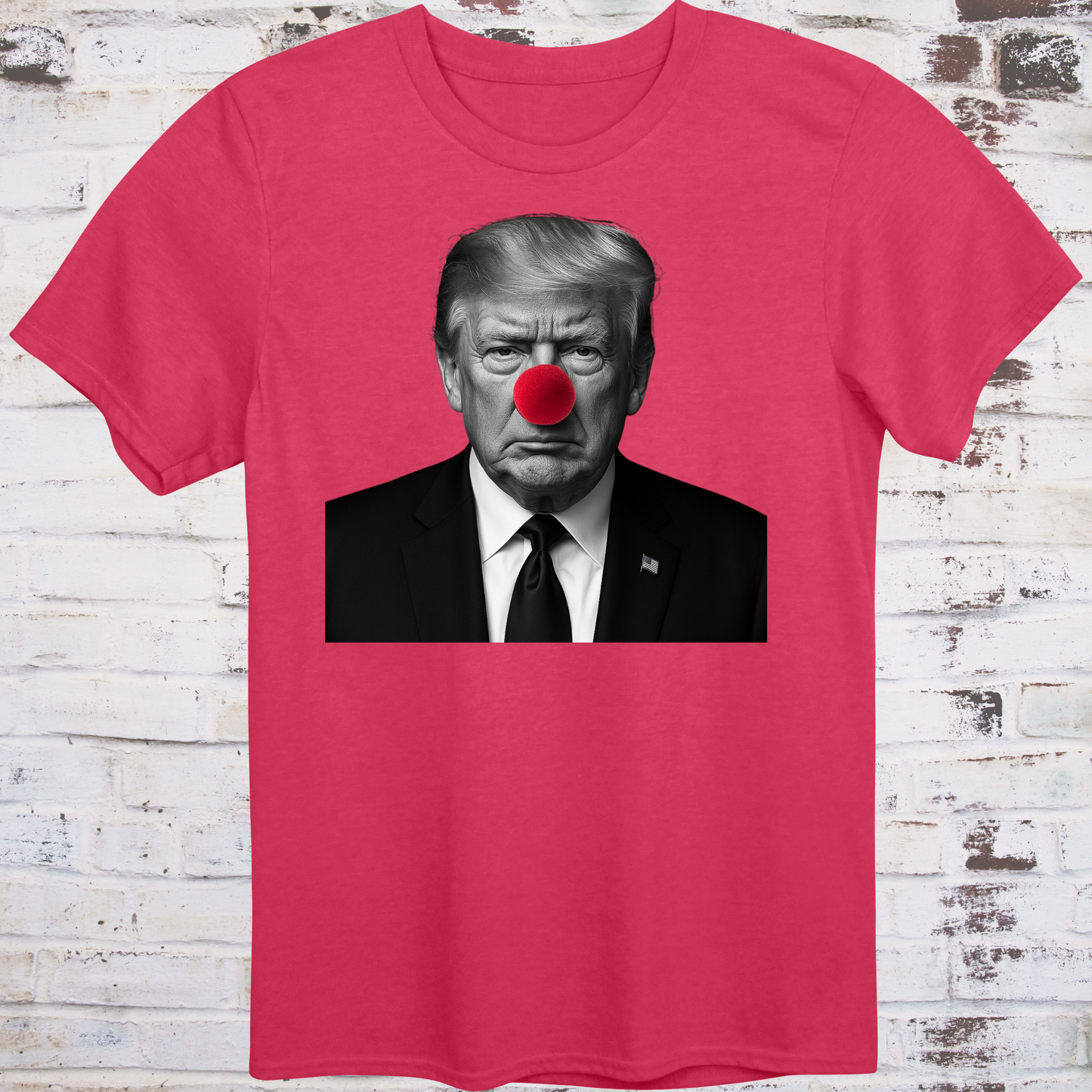 Red t-shirt with black-and-white photo of Donald Trump wearing a red clown nose –
minimalist parody protest shirt by Democratee’s