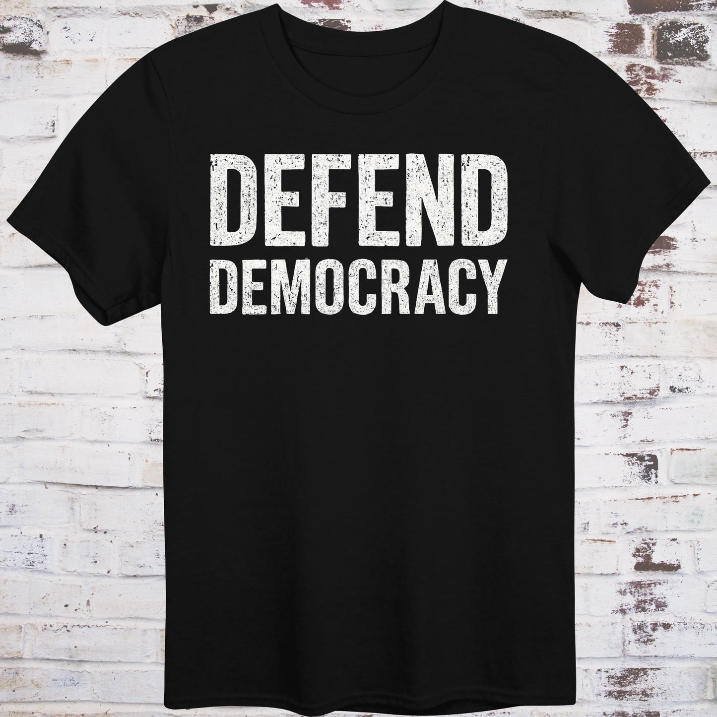 Black t-shirt with 'DEFEND DEMOCRACY' text on a wooden background