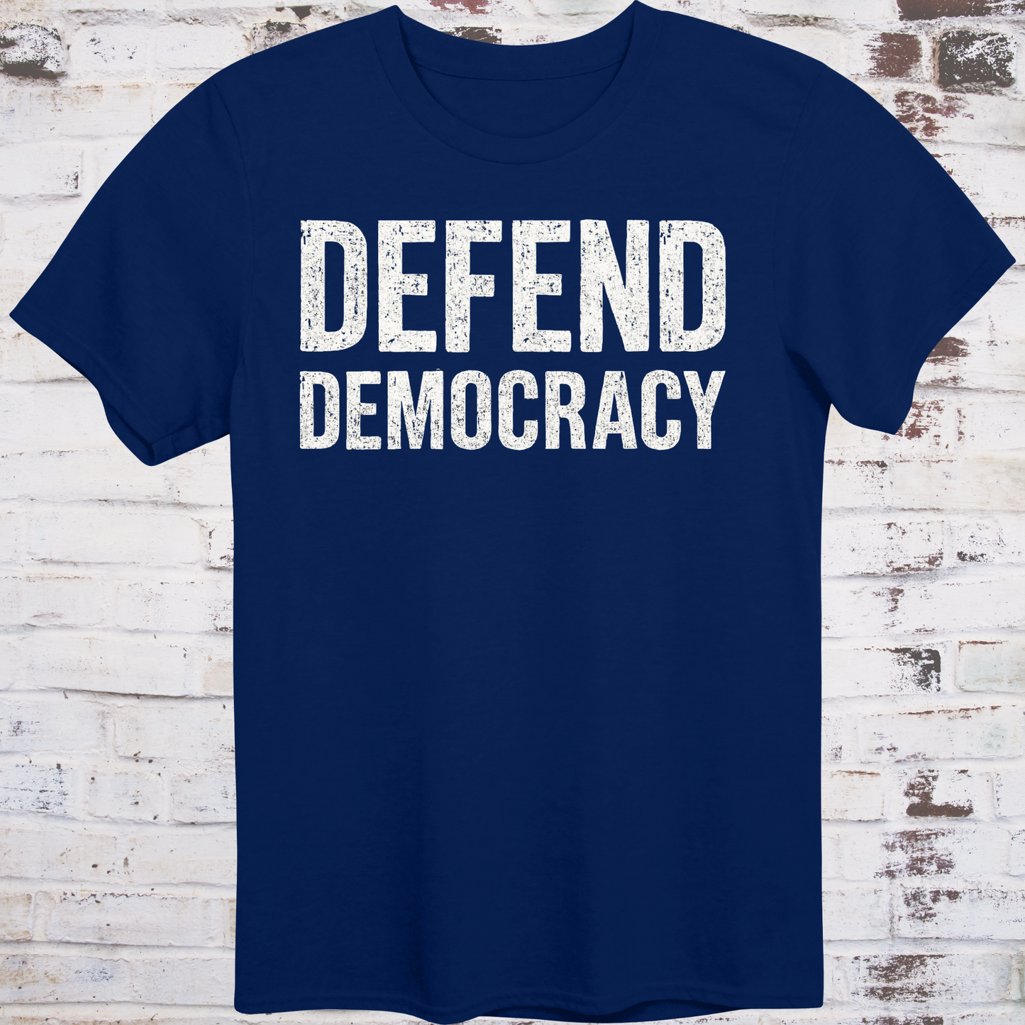 Navy blue t-shirt with 'DEFEND DEMOCRACY' text on a wooden background