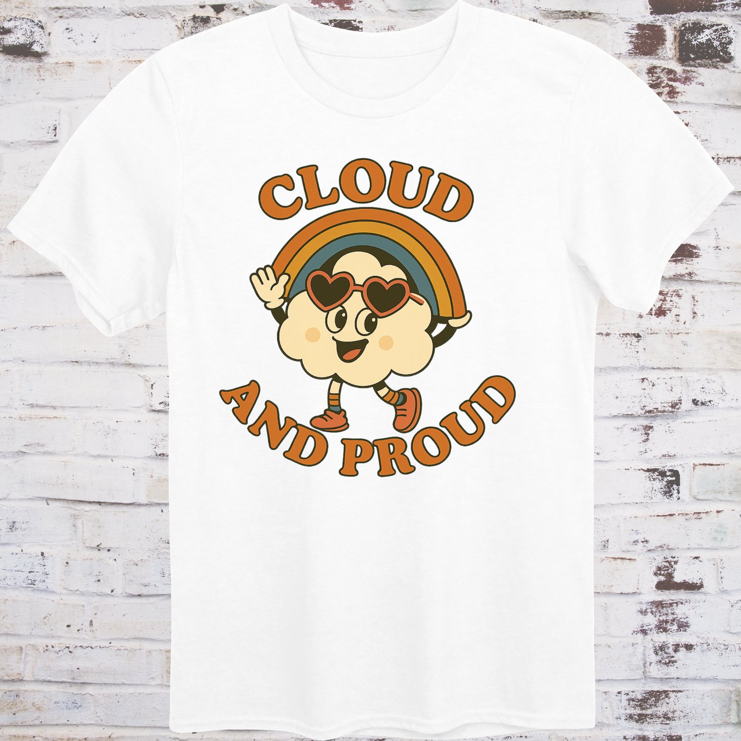 White t-shirt with cartoon cloud wearing heart sunglasses  
under a rainbow arch, with bold orange text reading "Cloud and Proud" –  
retro queer pride shirt by Democratee’s