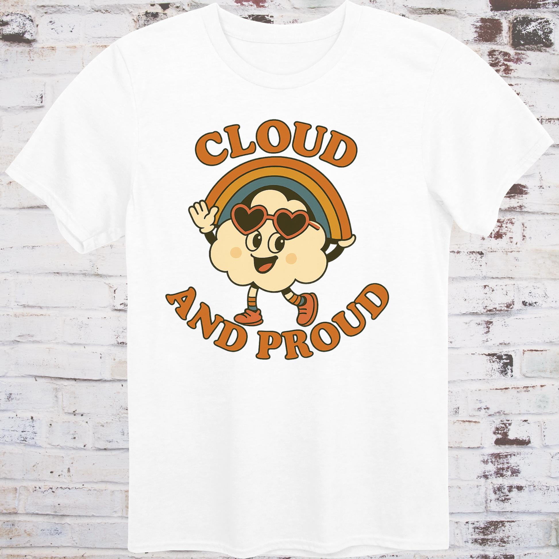 White t-shirt with cartoon cloud wearing heart sunglasses  
under a rainbow arch, with bold orange text reading "Cloud and Proud" –  
retro queer pride shirt by Democratee’s