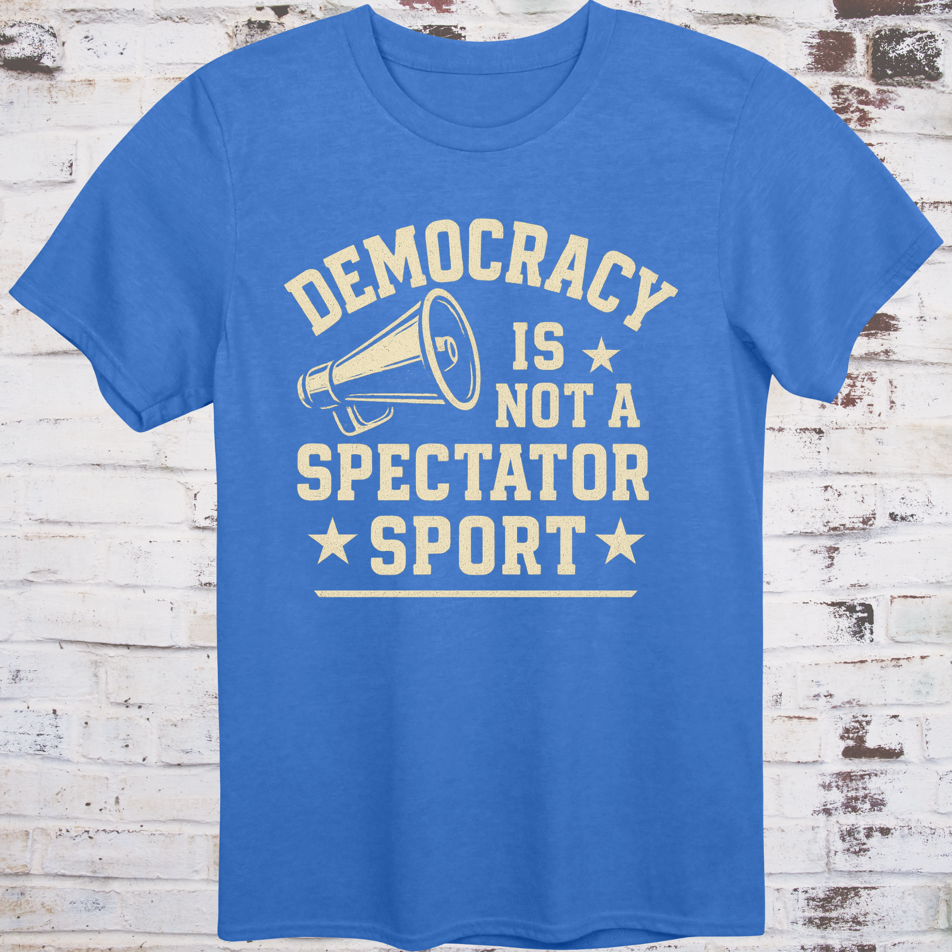 Blue t-shirt with vintage megaphone graphic and bold text reading  
"Democracy Is Not a Spectator Sport" – civic action apparel by Democratee’s