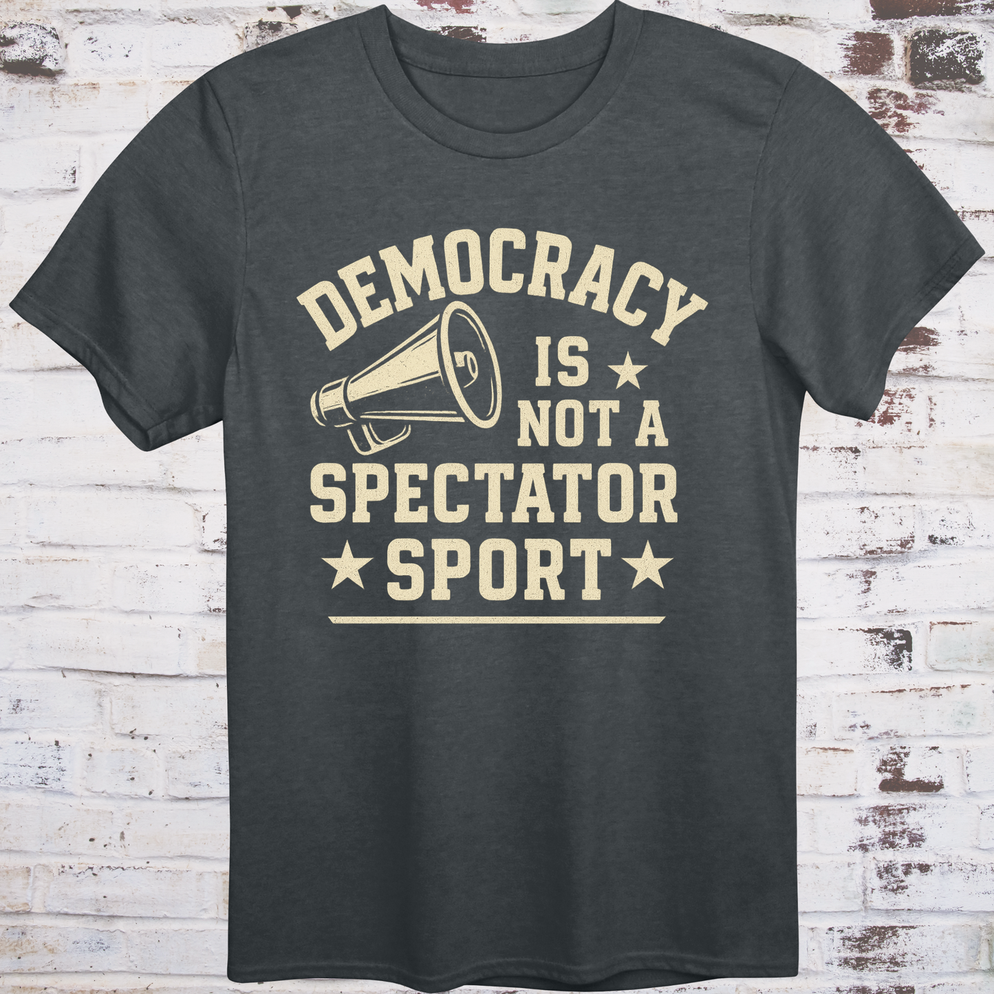 Gray t-shirt with vintage megaphone graphic and bold text reading  
"Democracy Is Not a Spectator Sport" – civic action apparel by Democratee’s