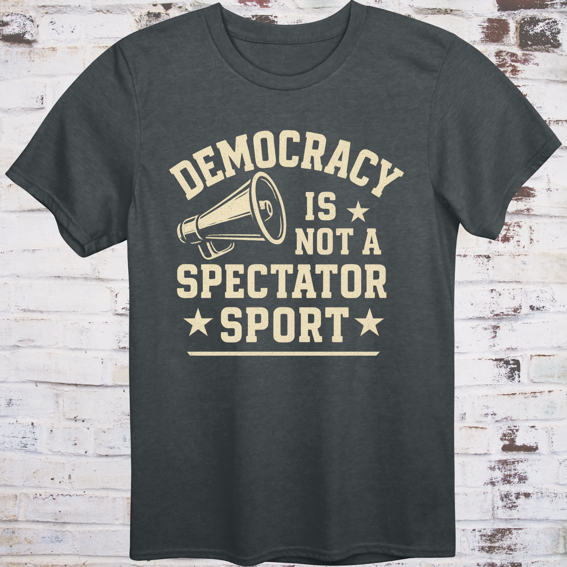 Gray t-shirt with vintage megaphone graphic and bold text reading  
"Democracy Is Not a Spectator Sport" – civic action apparel by Democratee’s