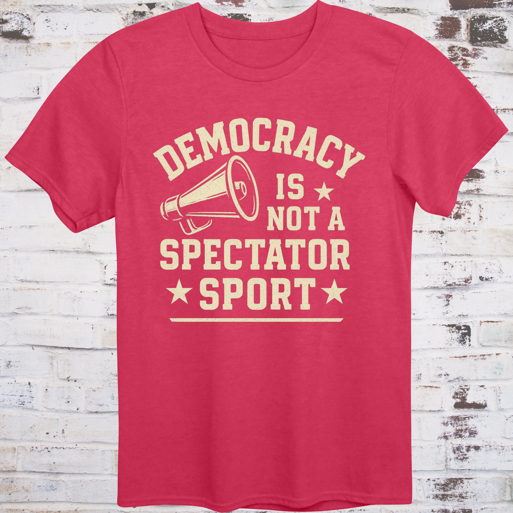 Red t-shirt with vintage megaphone graphic and bold text reading  
"Democracy Is Not a Spectator Sport" – civic action apparel by Democratee’s