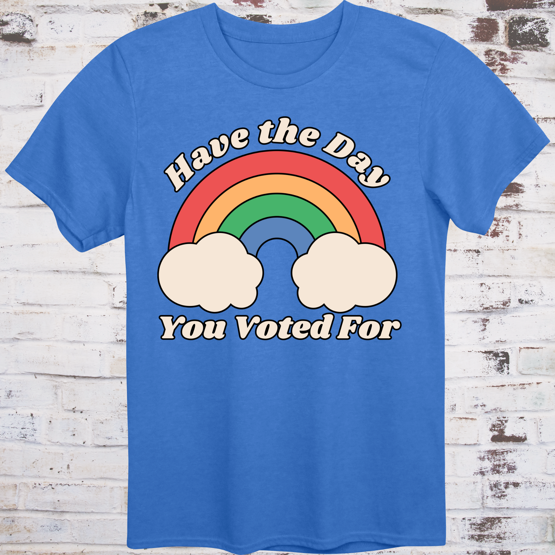 Blue t-shirt with retro rainbow graphic and white text reading  
“Have the Day You Voted For” – passive-aggressive protest shirt by Democratee’s