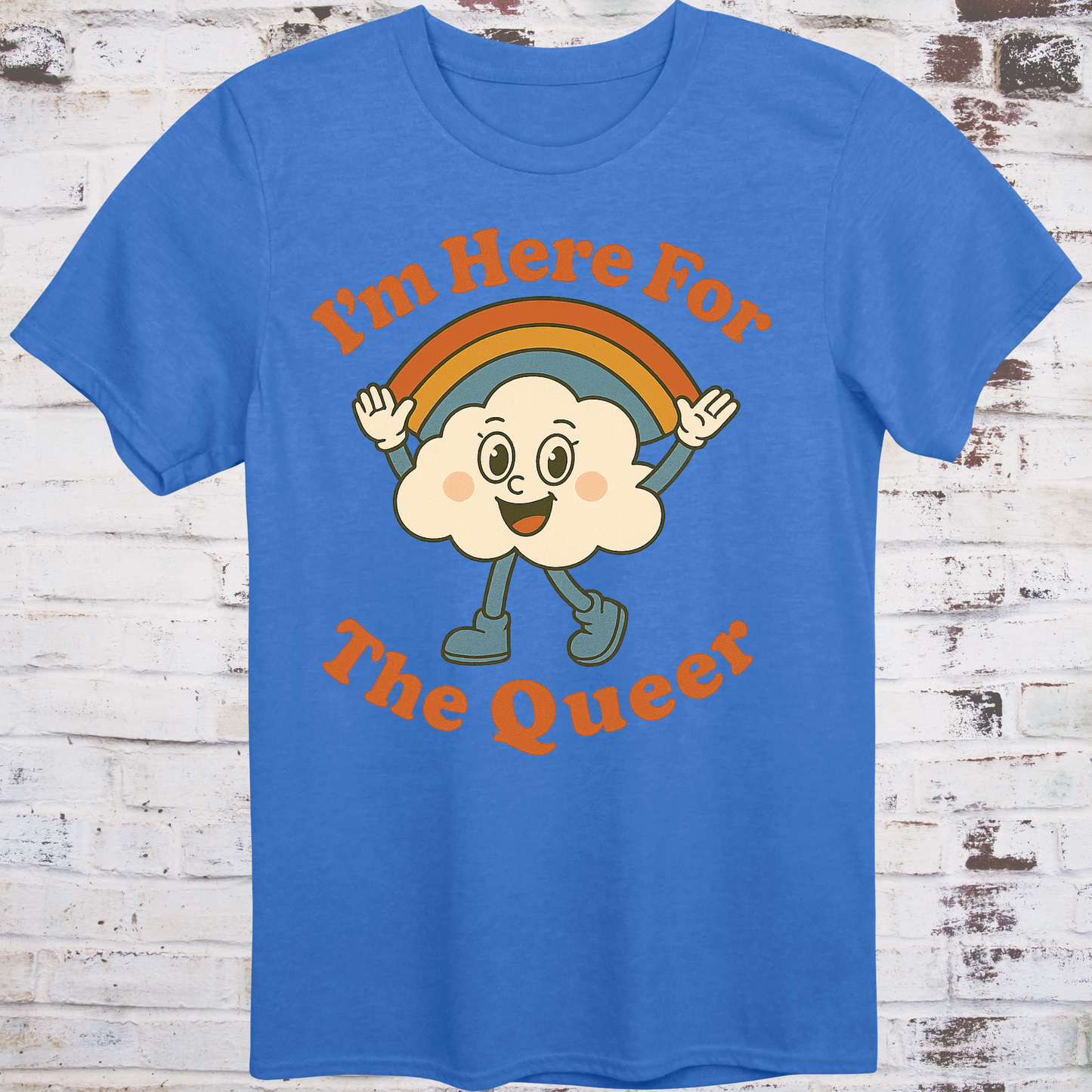 Blue t-shirt with retro-style cartoon cloud wearing boots and a rainbow,  
surrounded by bold text reading "I’m Here for the Queer" –  
inclusive pride shirt by Democratee’s