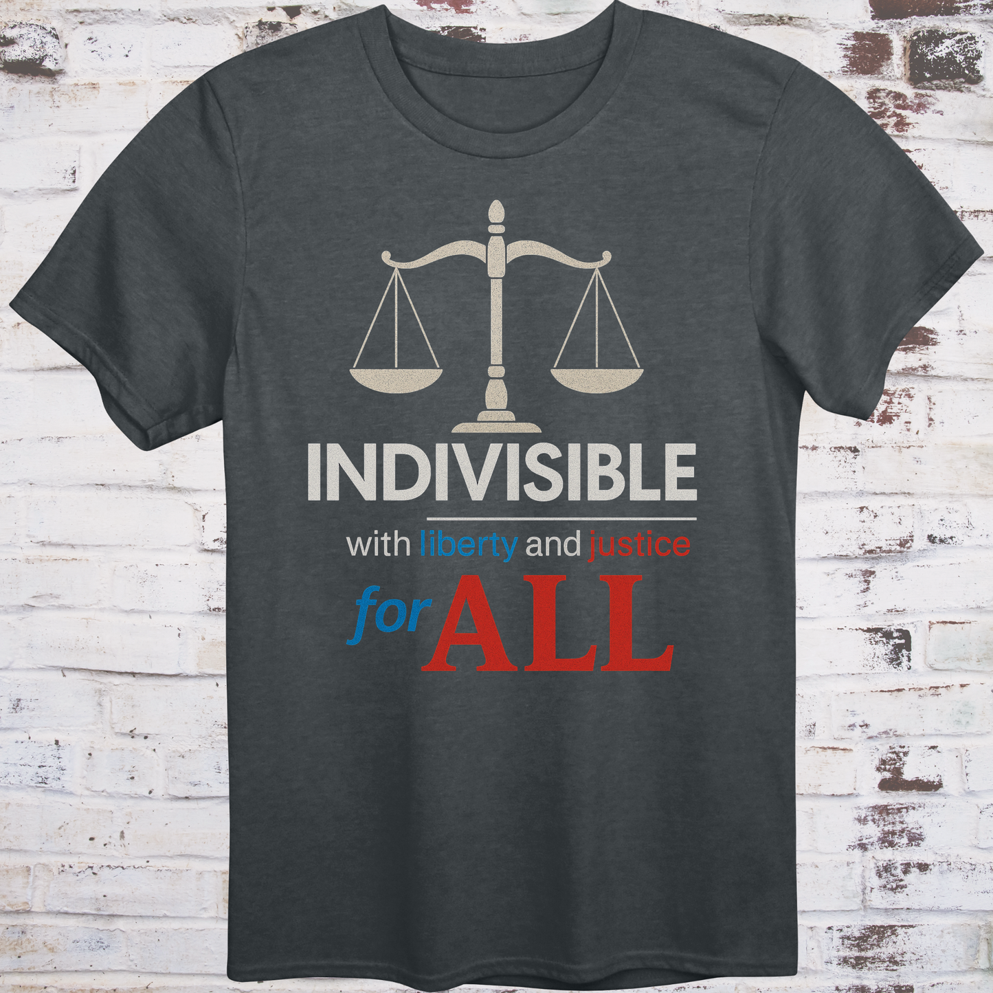 Gray t-shirt with balance scale graphic and bold text reading  
"Indivisible with liberty and justice for all" in red, white, and blue –  
progressive political shirt by Democratee’s