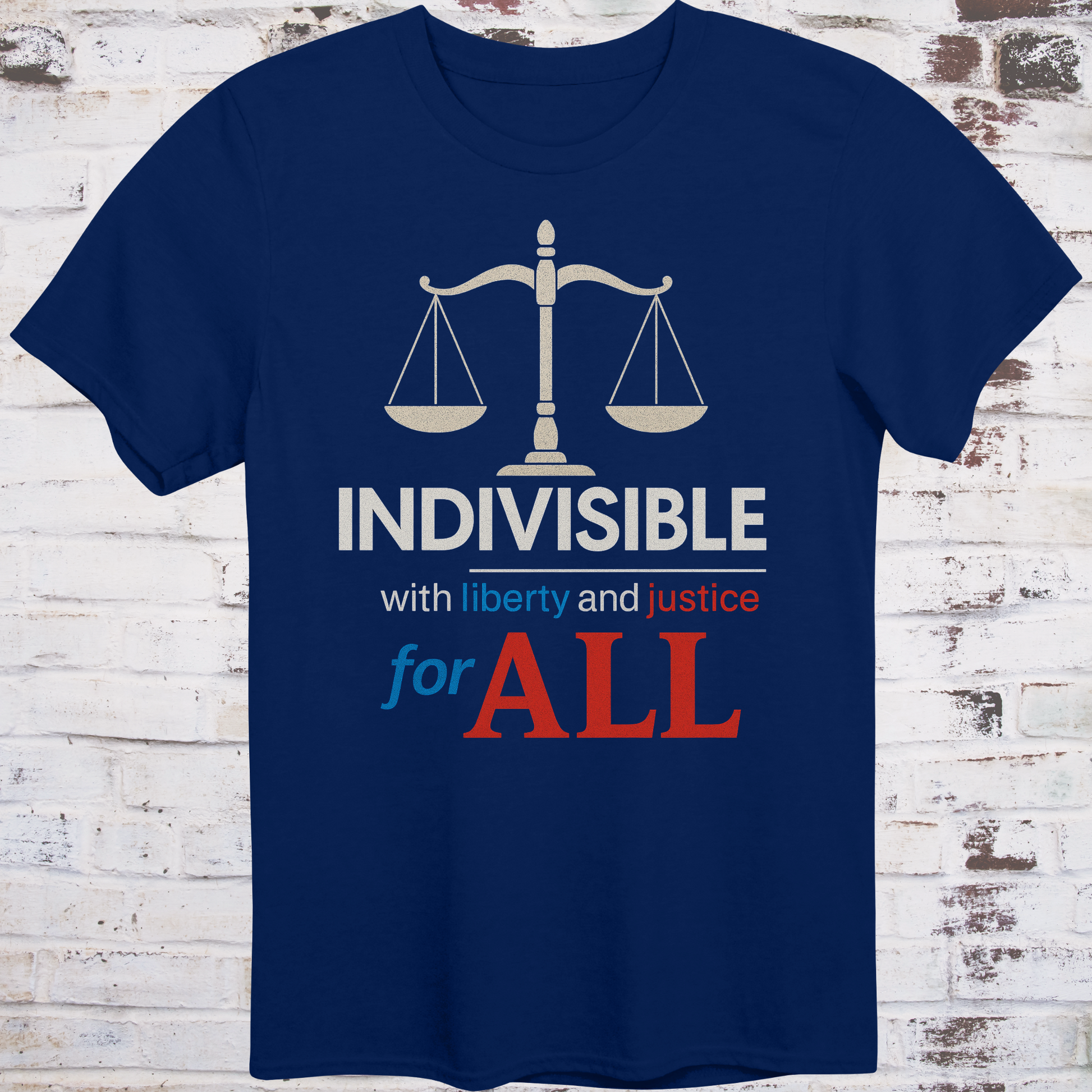 Navy t-shirt with balance scale graphic and bold text reading  
"Indivisible with liberty and justice for all" in red, white, and blue –  
progressive political shirt by Democratee’s
