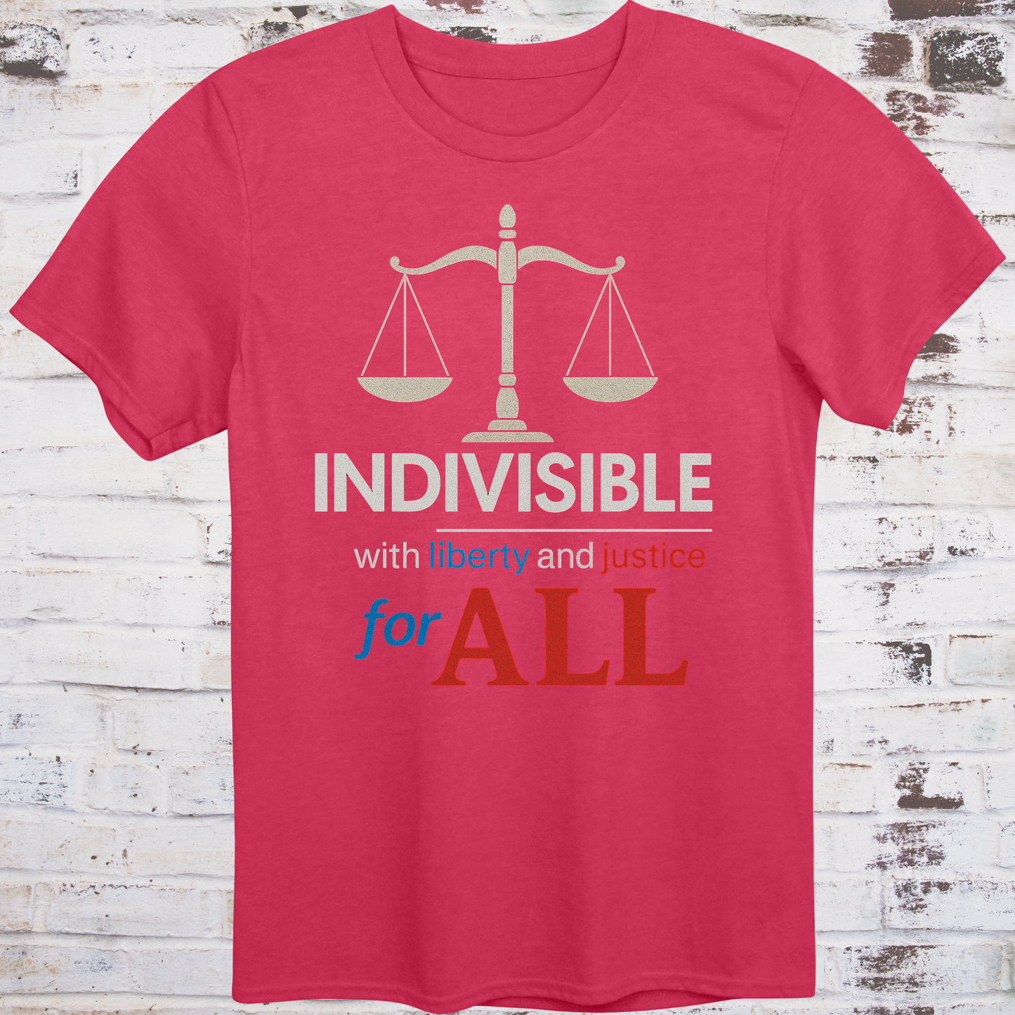 Red t-shirt with balance scale graphic and bold text reading  
"Indivisible with liberty and justice for all" in red, white, and blue –  
progressive political shirt by Democratee’s