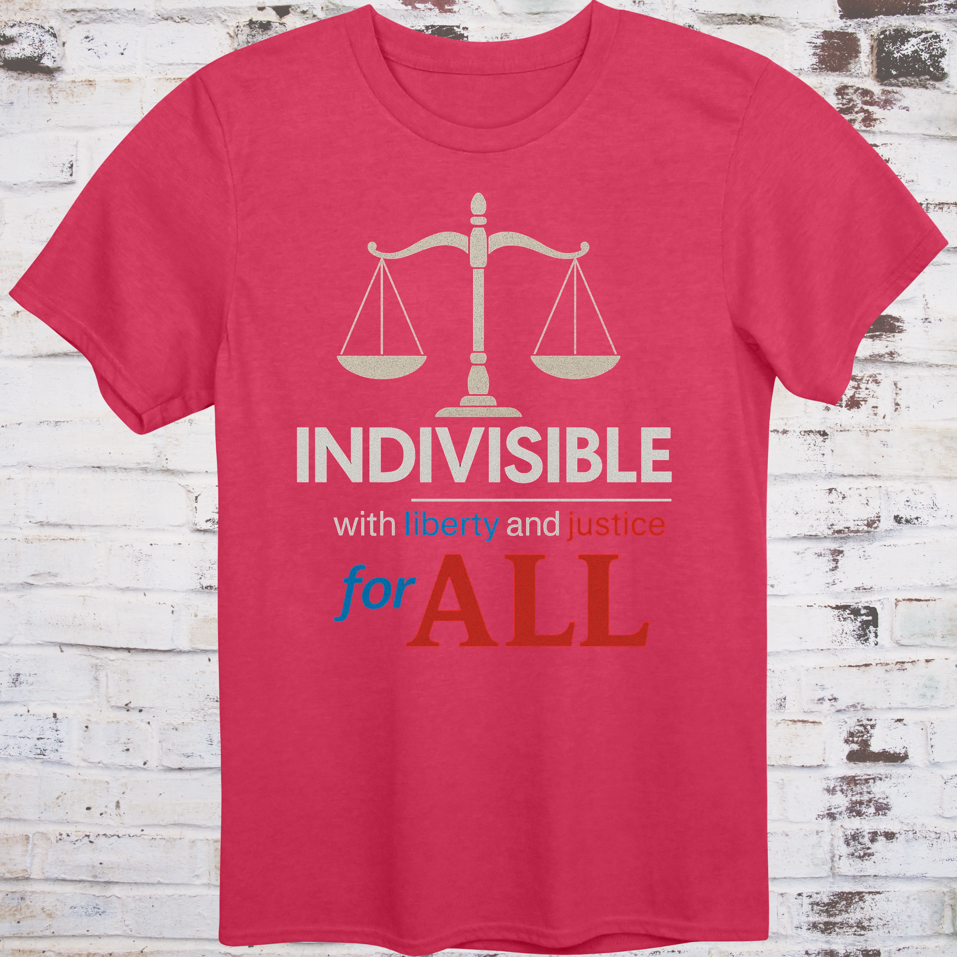 Red t-shirt with balance scale graphic and bold text reading  
"Indivisible with liberty and justice for all" in red, white, and blue –  
progressive political shirt by Democratee’s