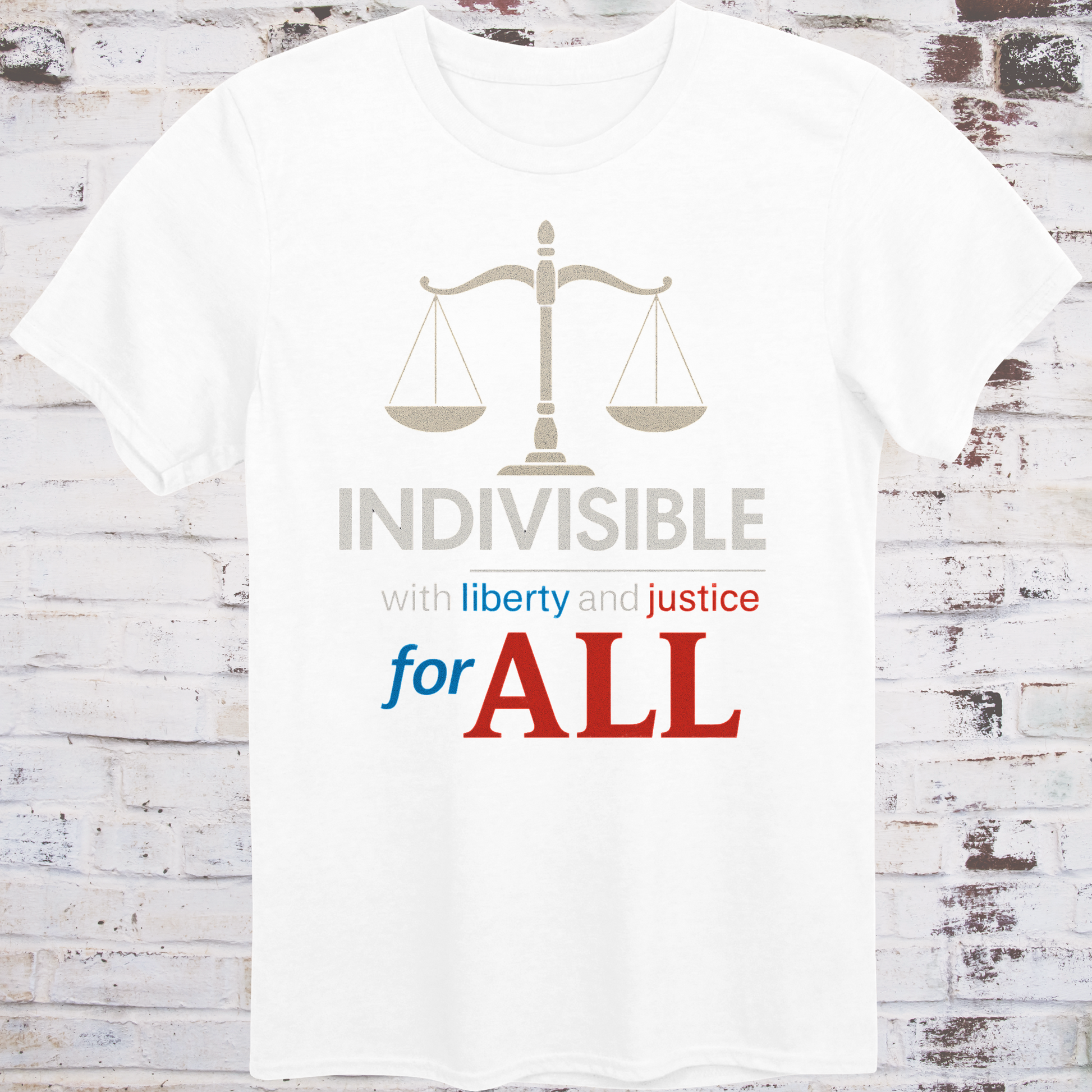 White t-shirt with balance scale graphic and bold text reading  
"Indivisible with liberty and justice for all" in red, white, and blue –  
progressive political shirt by Democratee’s