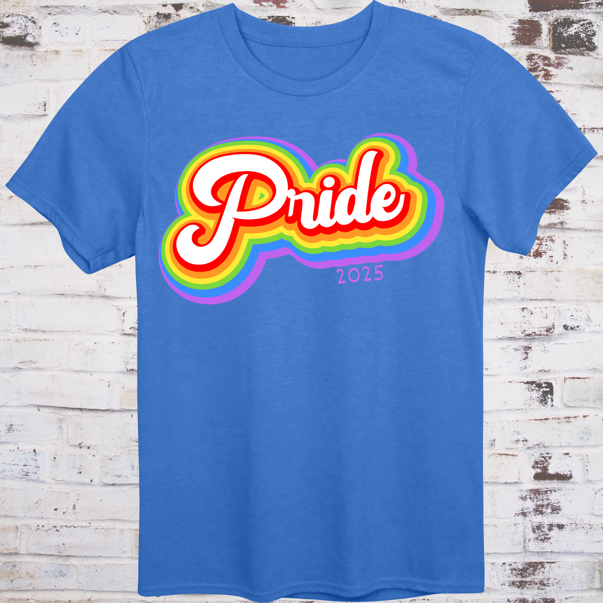 Blue t-shirt with colorful rainbow bubble-style script reading  
“Pride 2025” in bold retro font – queer celebration shirt by Democratee’s