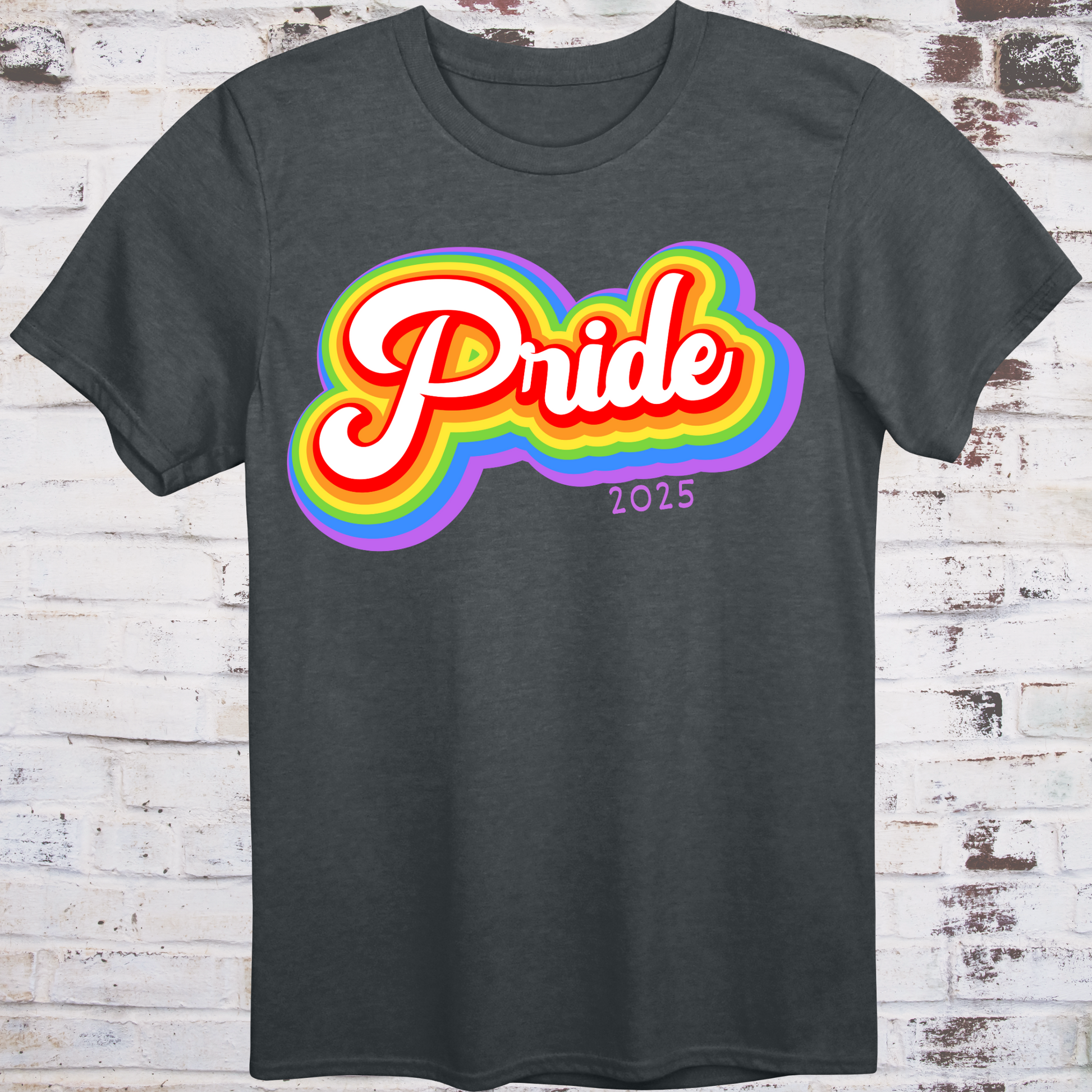 Gray t-shirt with colorful rainbow bubble-style script reading  
“Pride 2025” in bold retro font – queer celebration shirt by Democratee’s