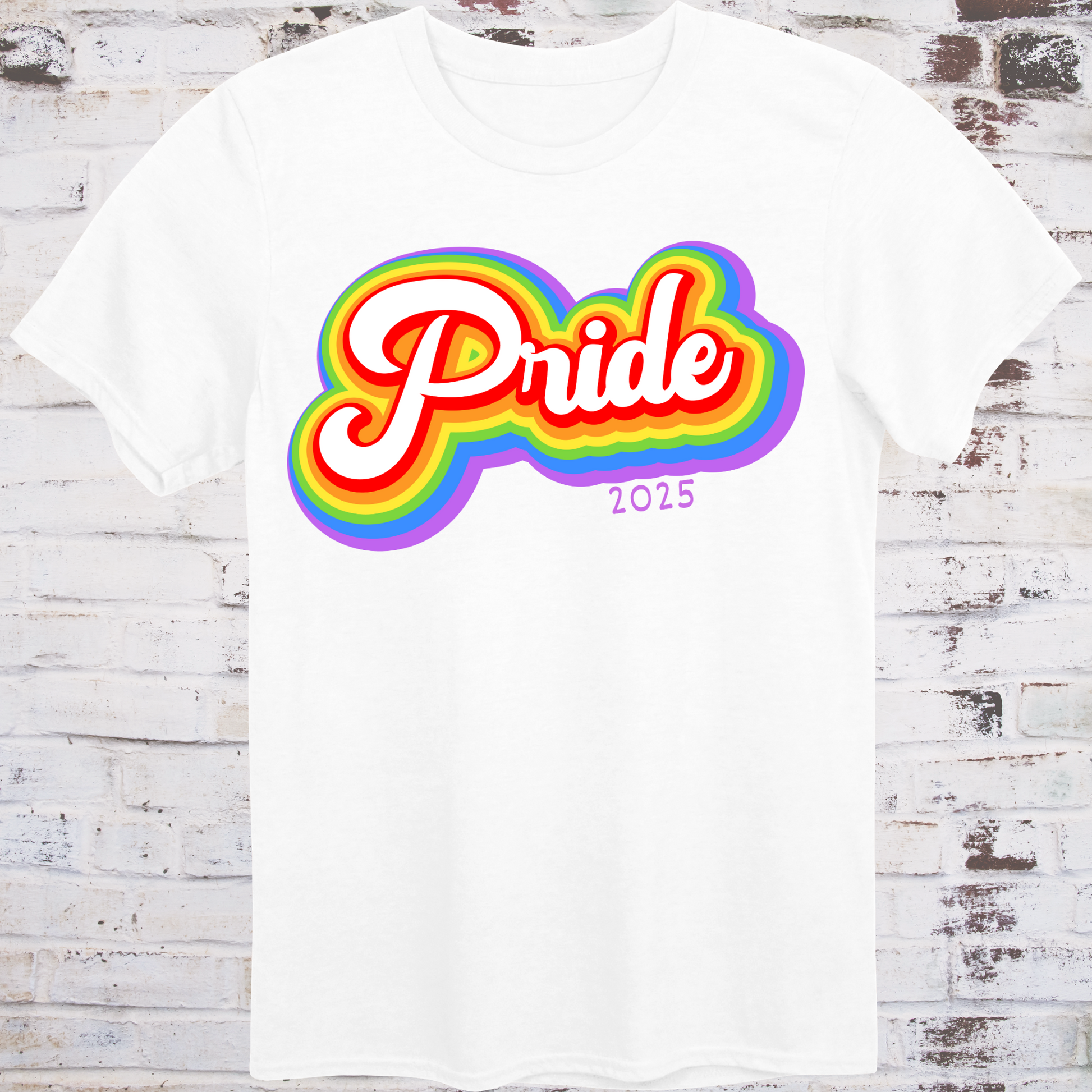 White t-shirt with colorful rainbow bubble-style script reading  
“Pride 2025” in bold retro font – queer celebration shirt by Democratee’s