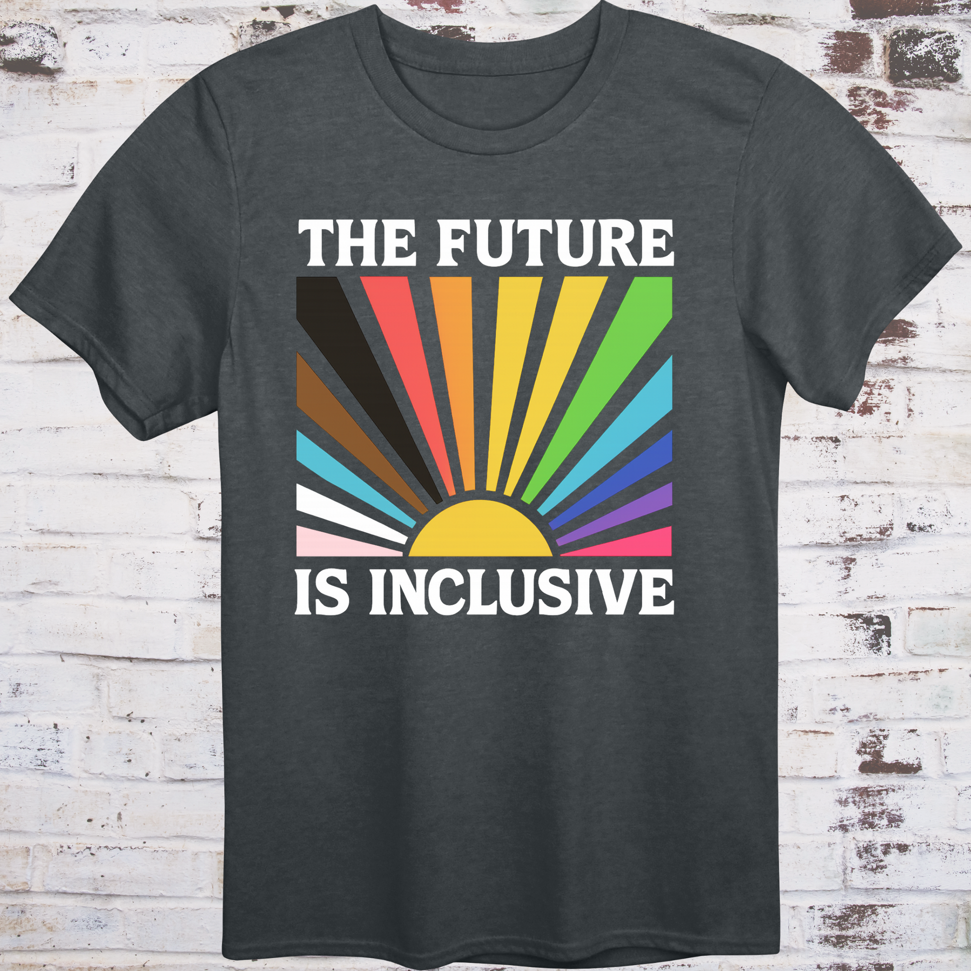Gray t-shirt with retro-style sunburst in progress pride flag colors  
and bold white text reading "The Future Is Inclusive" –  
intersectional activist shirt by Democratee’s