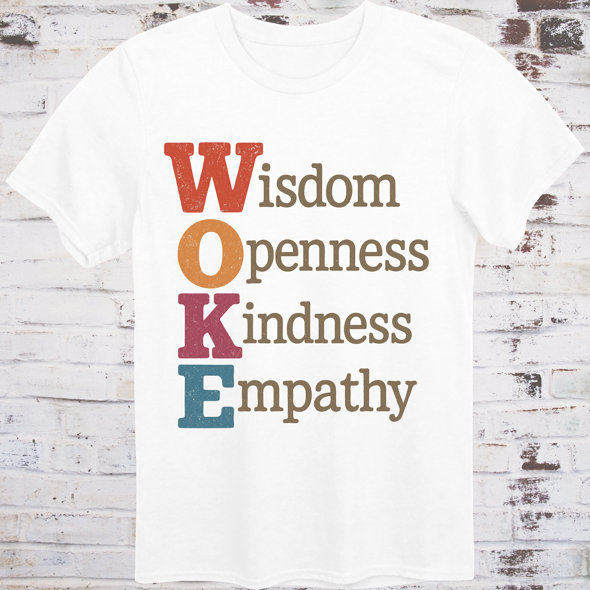 White t-shirt with bold vertical WOKE acronym in colorful letters,  
spelling out Wisdom, Openness, Kindness, and Empathy –  
reclaimed progressive shirt by Democratee’s