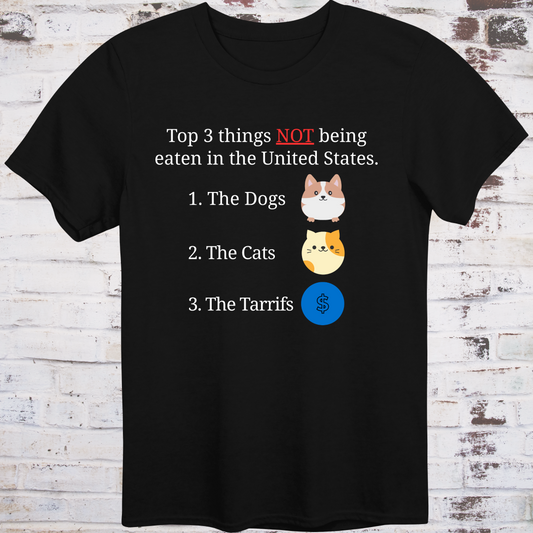 Black t-shirt with cartoon icons of a dog, a cat, and a dollar sign  
next to text listing “Top 3 Things NOT Being Eaten in the United States” –  
funny political parody shirt by Democratee’s