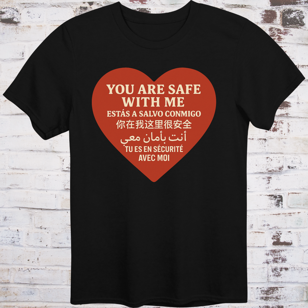Black T-shirt with heart graphic reading “You Are Safe With Me” in six languages including English, Spanish, Chinese, Arabic, and French