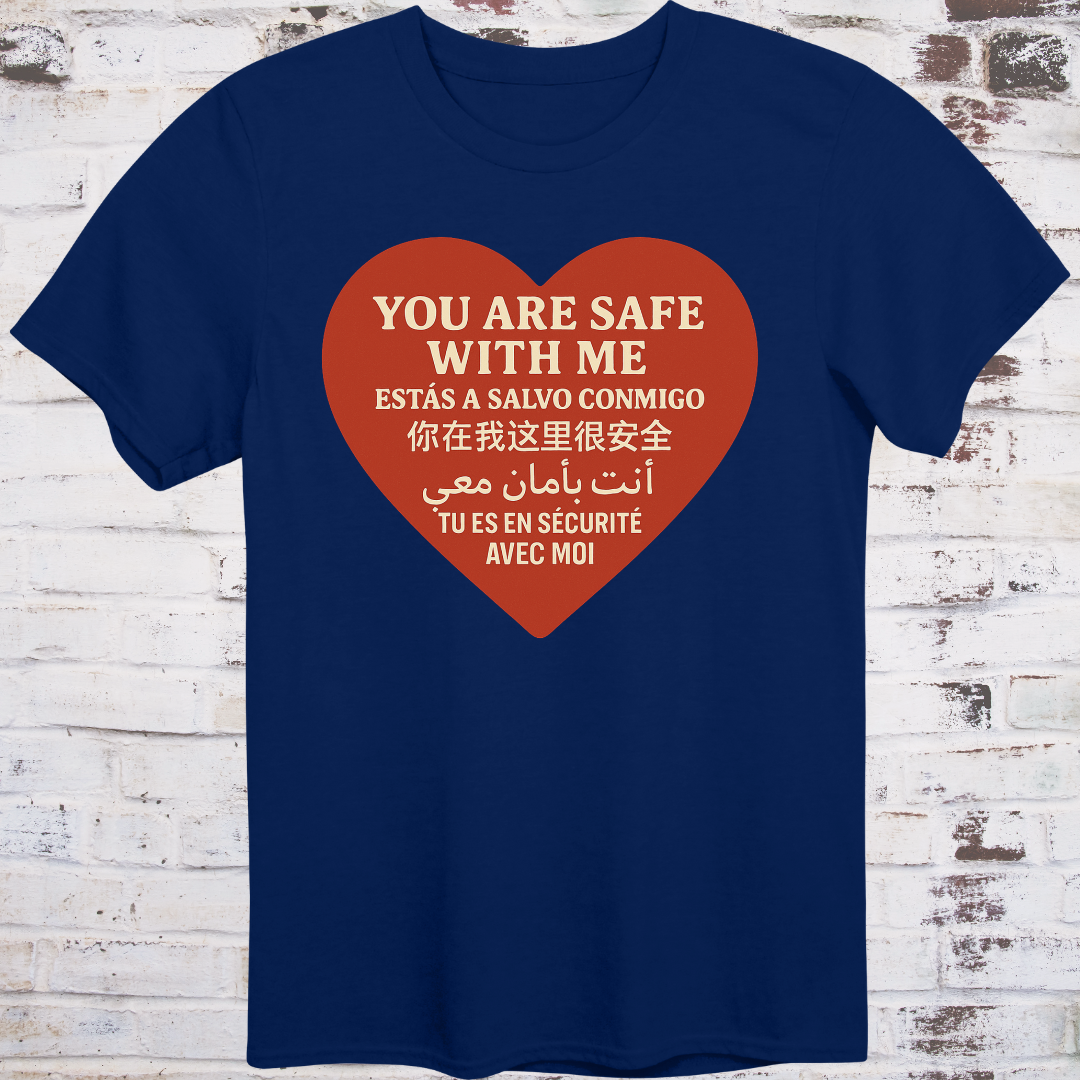 Navy T-shirt with heart graphic reading “You Are Safe With Me” in six languages including English, Spanish, Chinese, Arabic, and French
