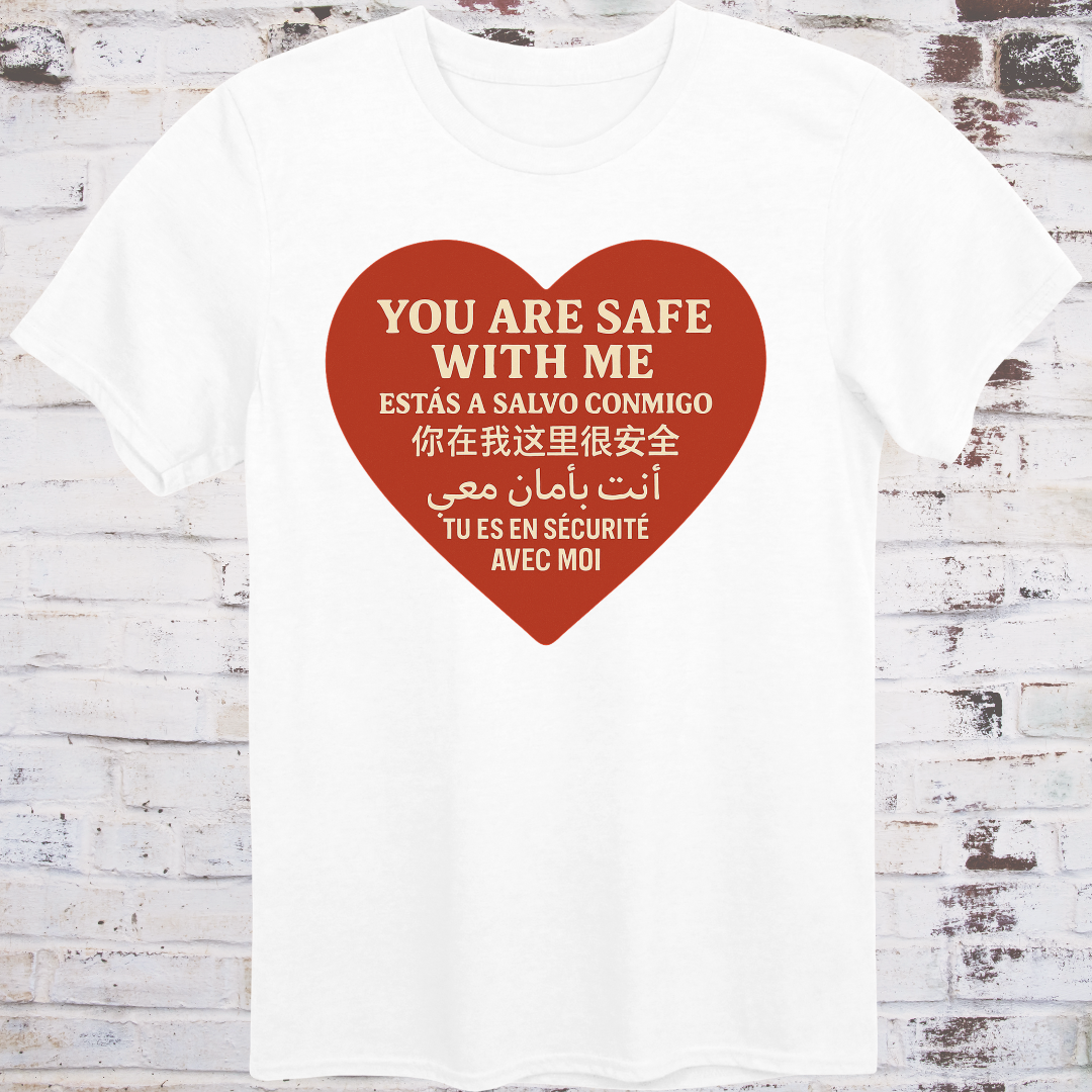 White T-shirt with heart graphic reading “You Are Safe With Me” in six languages including English, Spanish, Chinese, Arabic, and French