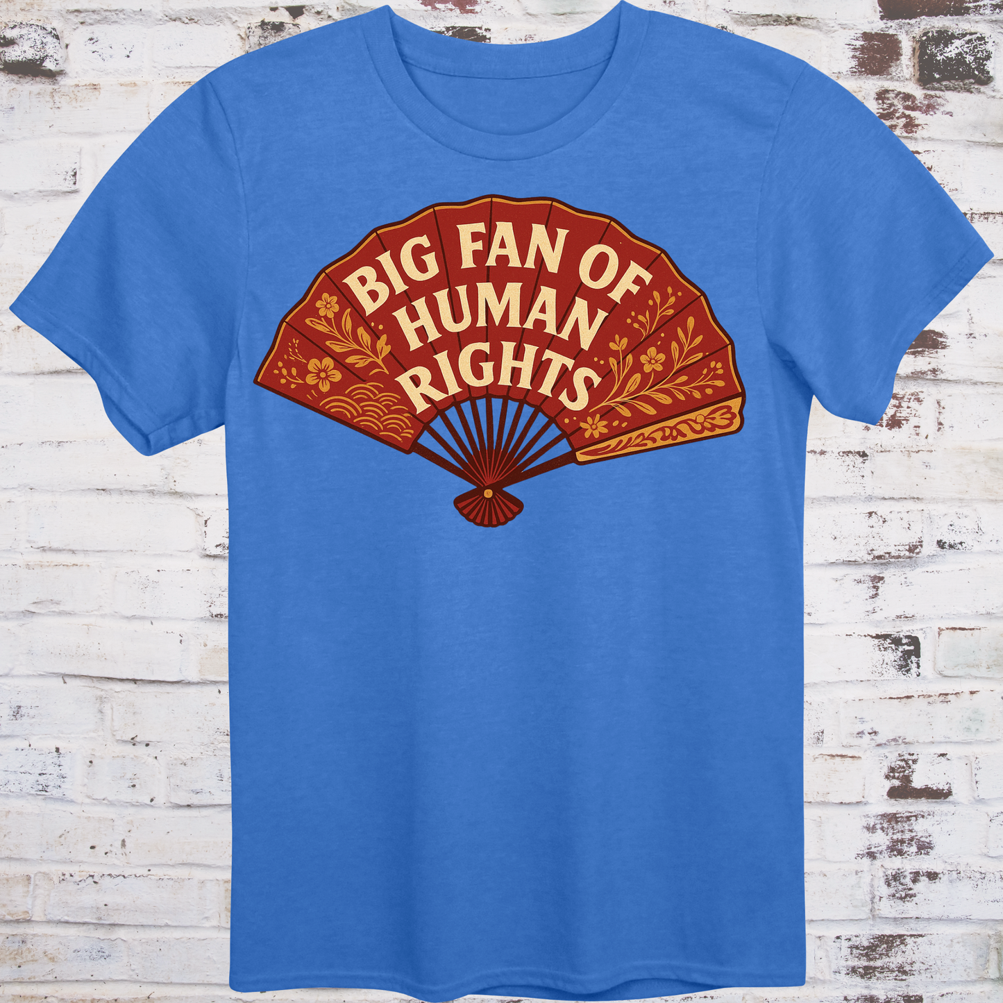 Blue t-shirt with a red fan graphic and 'Big Fan of Human Rights' text on a wooden background