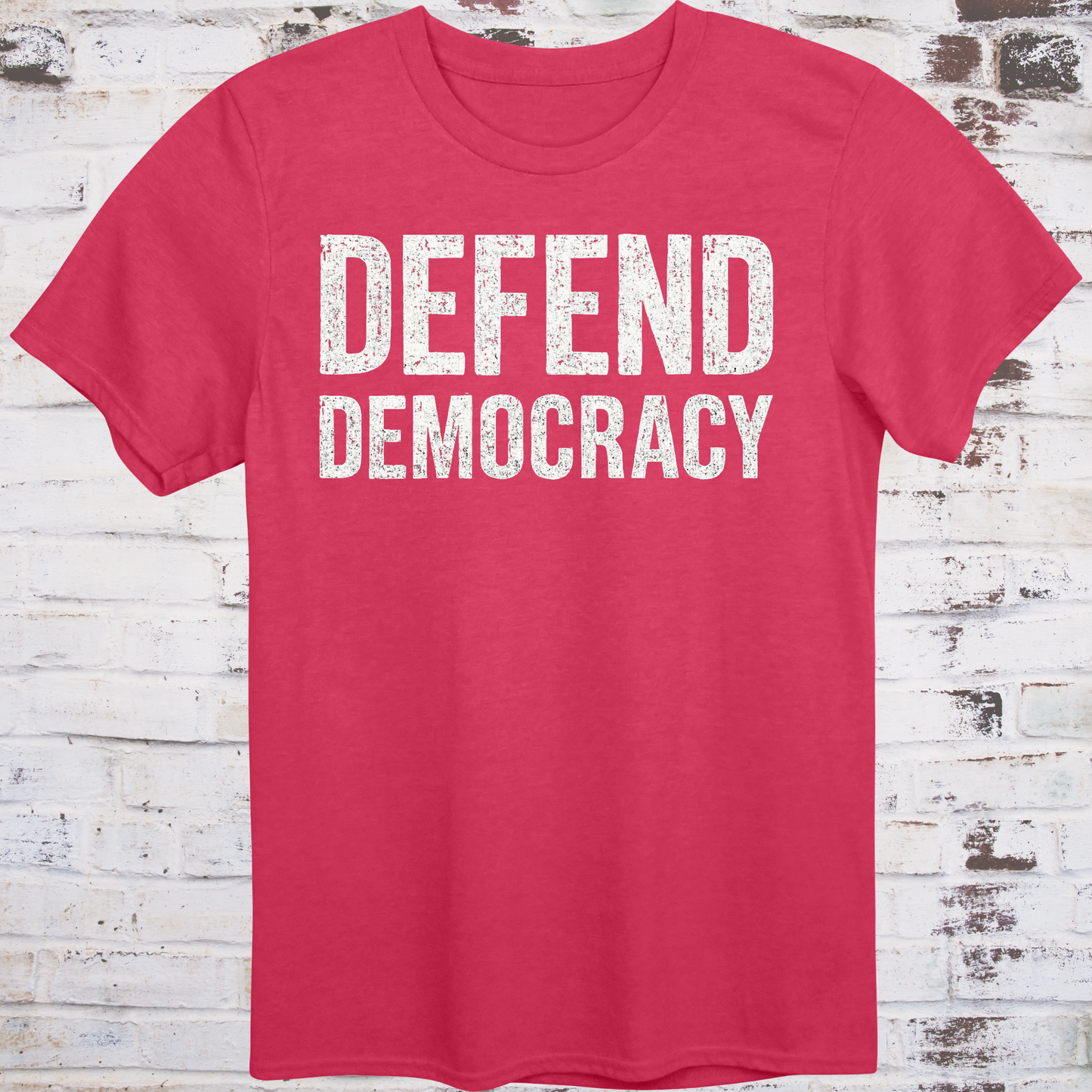 Red t-shirt with 'DEFEND DEMOCRACY' text on a wooden background