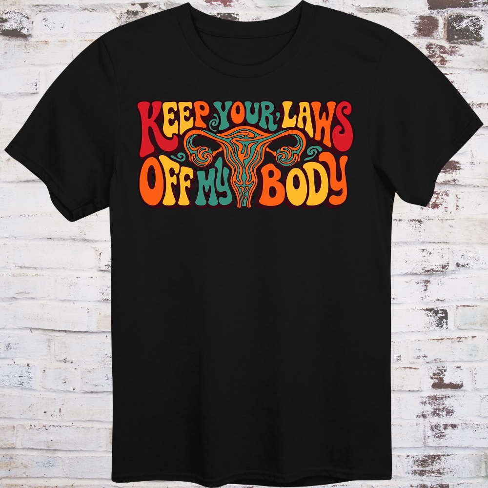 Keep Your Laws Off My Body in massive interlocking 70s bubble letters in deep red, teal, and orange around a stylized uterus, on a warm mustard yellow background.