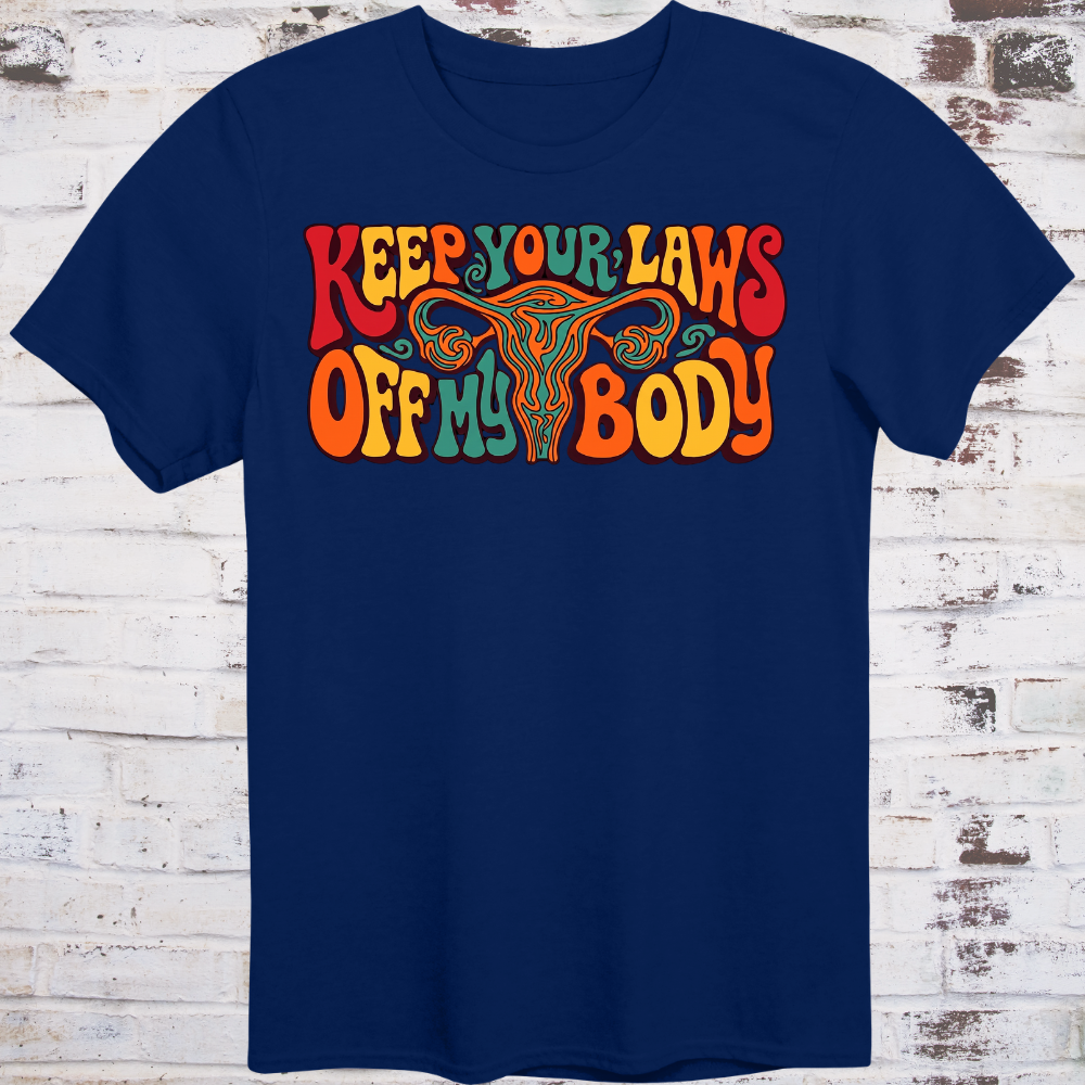 Keep Your Laws Off My Body in massive interlocking 70s bubble letters in deep red, teal, and orange around a stylized uterus, on a warm mustard yellow background.