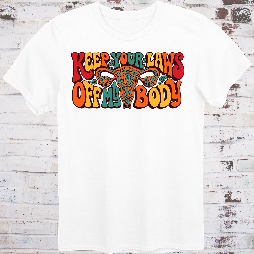 Keep Your Laws Off My Body in massive interlocking 70s bubble letters in deep red, teal, and orange around a stylized uterus, on a warm mustard yellow background.