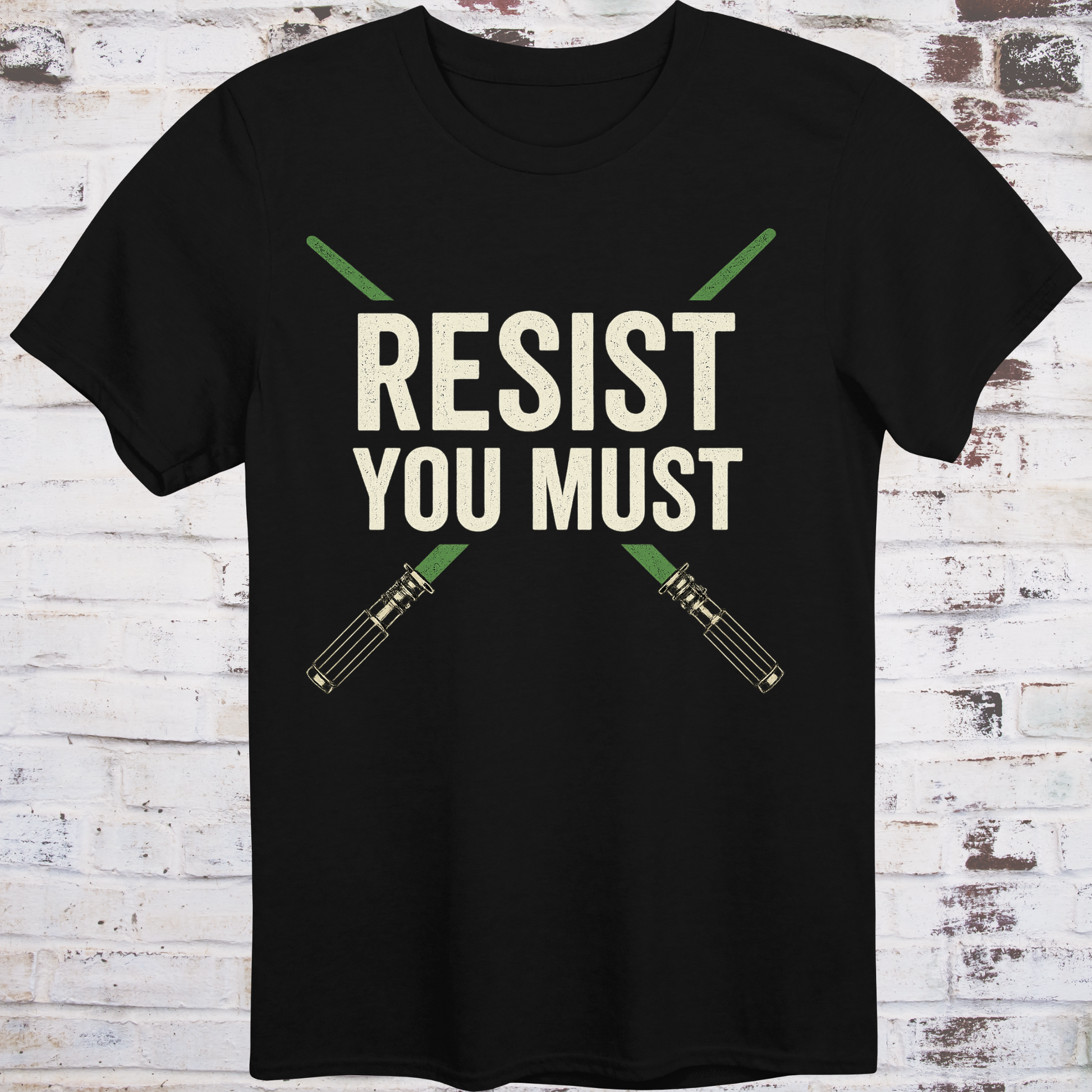 Sci-fi protest tee with green lightsabers and bold block text: “Resist You Must”