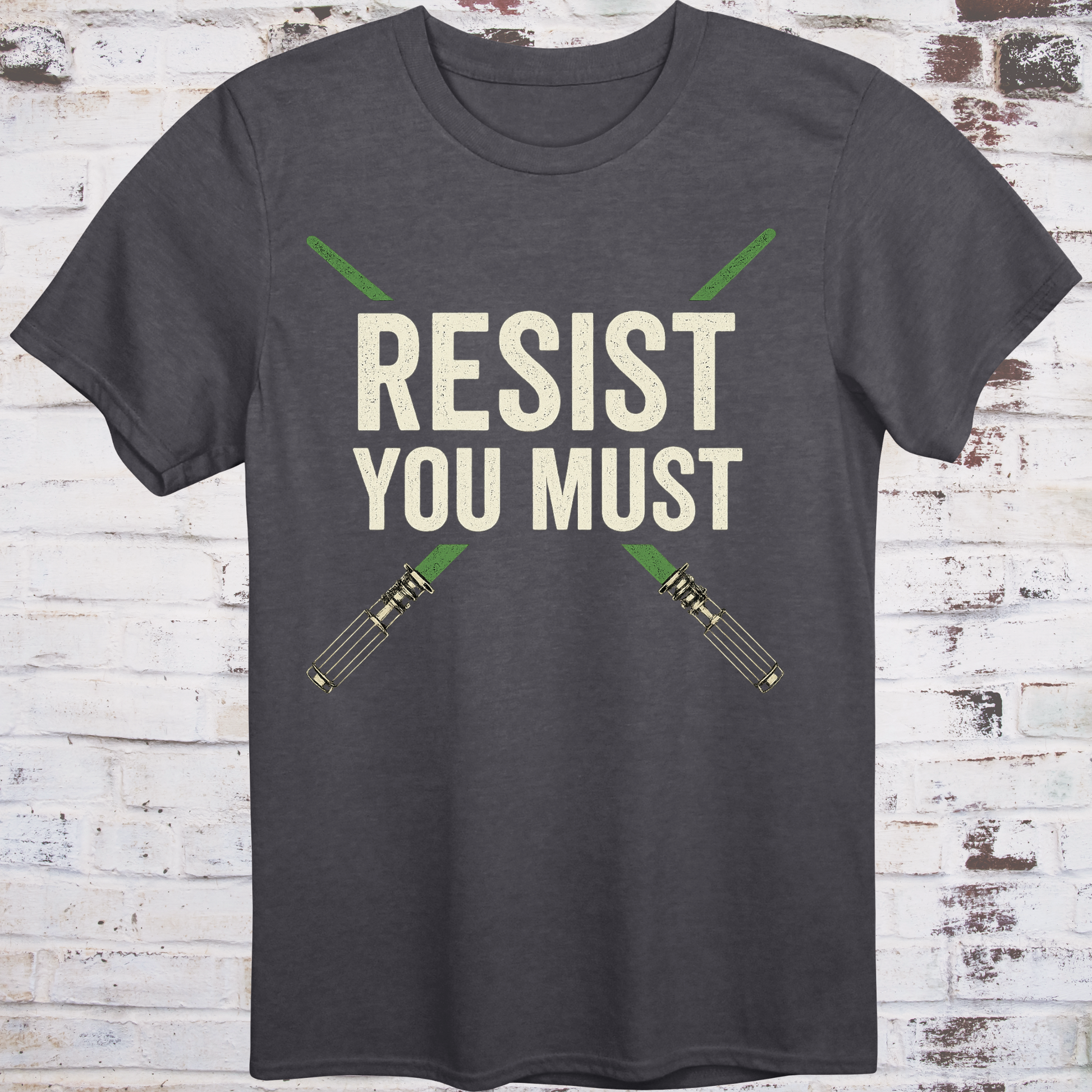 Sci-fi protest tee with green lightsabers and bold block text: “Resist You Must”