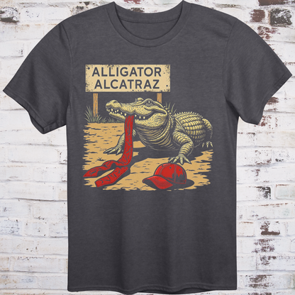 Black t-shirt with an alligator graphic and 'Alligator Alcatraz' text on a wooden background